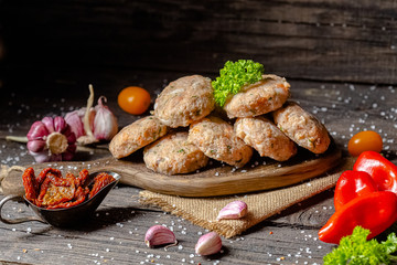 homemade meatballs, cutlets raw from red and white fish meat, in a vintage rustic plate bowl, fork...