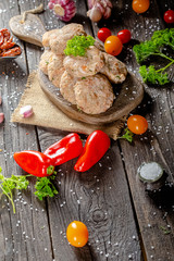 homemade meatballs, cutlets raw from red and white fish meat, in a vintage rustic plate bowl, fork...