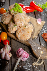 homemade meatballs, cutlets raw from red and white fish meat, in a vintage rustic plate bowl, fork...