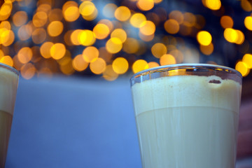  Aromatic coffee with a pattern in a glass cup on a brick wall background.