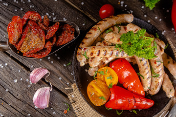homemade hotdog sausages fried from red and white fish meat, in a vintage rustic plate bowl, fork...