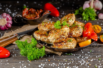homemade meatballs, cutlets fried from red and white fish meat, in a vintage rustic bowl plate,...