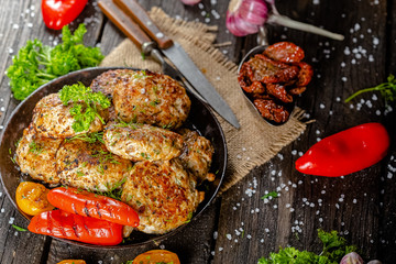homemade meatballs, cutlets fried from red and white fish meat, in a vintage rustic bowl plate,...