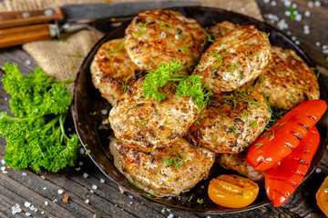 homemade meatballs, cutlets fried from red and white fish meat, in a vintage rustic bowl plate,...