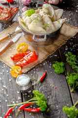 dumplings made of red and white fish meat, in a vintage rustic bowl plate, fork knife spoon, salt,...
