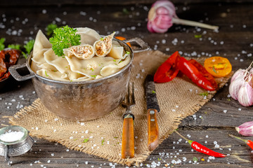 dumplings made of red and white fish meat, in a vintage rustic bowl plate, fork knife spoon, salt,...