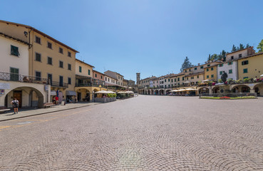 Fototapeta na wymiar The beautiful Matteotti square in triangular shape in the historic center of Greve in Chianti, Florence, Tuscany, Italy