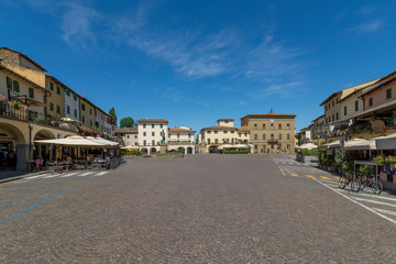 The beautiful Matteotti square in triangular shape in the historic center of Greve in Chianti, Florence, Tuscany, Italy