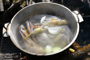 Cooking fish soup in pot