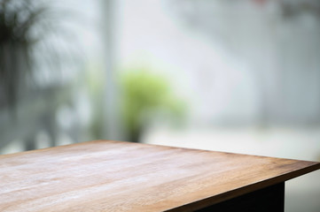 empty wood table with blur montage coffee shop or restaurant background.