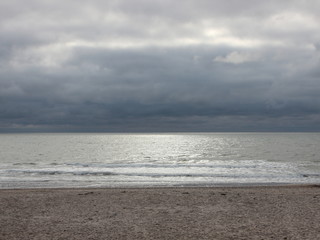 Ocean with Silver Surface and Dark Clouds