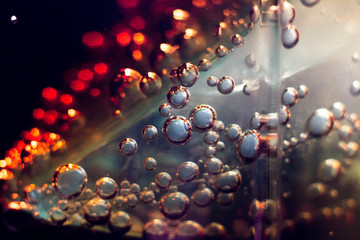 the bubbles in a glass of dark fizzy drink
