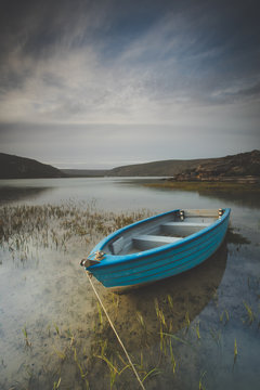 Wide angle landscape image of an old fishing boat in an estuary in South Africa
