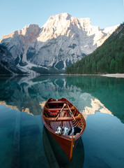 dog on lake braies in italy. Australian Shepherd in a boat. pet travel to Lago di Braies