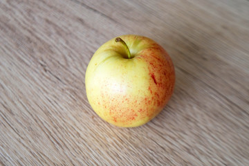 close up red apple isolated on wood background