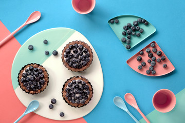 Top view on mini blueberry custard cakes for kids birthday party