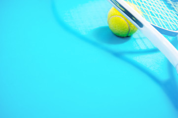 Tennis racket and ball sports on blue background