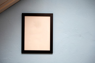 Mock up black frame on blue wall. background texture, space for text
