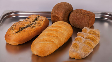 different types of bread on a metal tray
