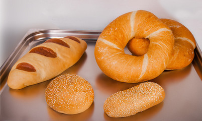 different types of bread on a metal tray