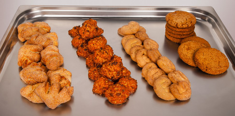 different types of cookies on a metal tray