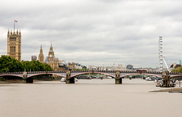 Fototapeta premium Thames river view with main London attractions on background: Big Ben, London Eye and Houses of Parliament