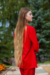 Back view close up portrait young beautiful blonde model in red dress