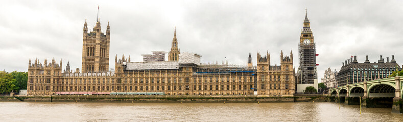 Fototapeta na wymiar Houses of Parliament and Big Ben clock tower covered with scaffolding for restoration, London, England