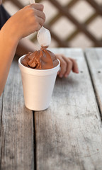 Cup of Chocolate Ice Cream on a Rustic Wooden Table