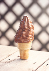 A Chocolate Soft Serve Ice Cream Cone Melting in the Summer Heat