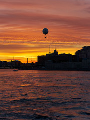 evening sunset over the city and the Neva river with a balloon in the golden sky, St. Petersburg