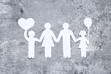Family figures with heart on grey background