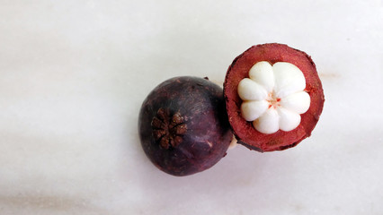 Top view of a mangosteen, with its white fleshes. Mangosteen is referred to as 