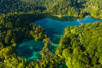Fototapeta na wymiar Aerial view of turquoise waters of Plitvice Lakes on a sunny summer day. Plitvice National Park, Croatia.