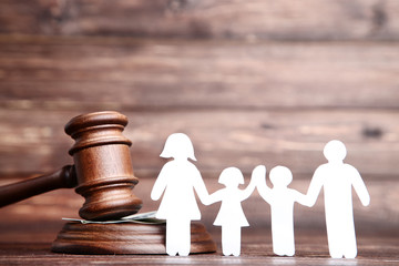 Family figures with gavel on brown wooden table
