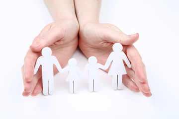 Fototapeta na wymiar Family figures in female hands on white background