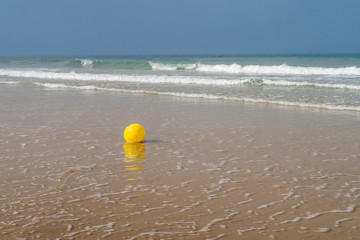 marine buoy stranded on the beach sand