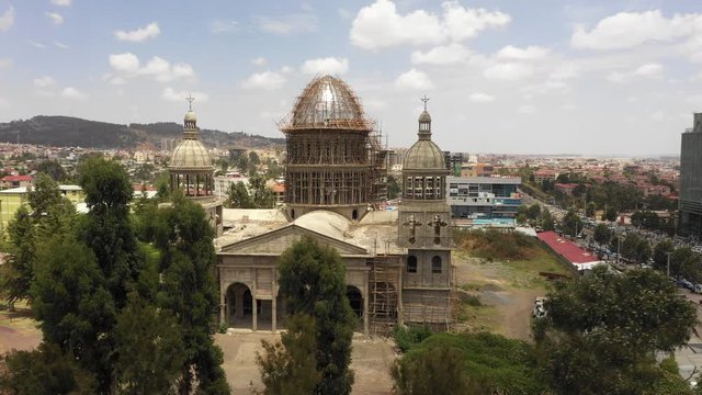 Rotating drone shot of spectacular Christian Orthodox cathedral under construction in Addis Ababa, religion and architecture in Ethiopia Africa