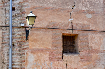 Black lantern on old brick wall whit window