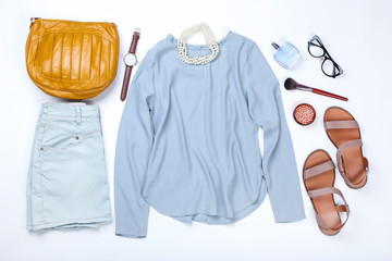 Modern women's clothes with accessories on white background