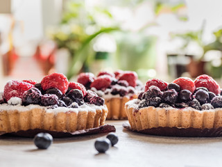 tarts with fresh raspberries and blueberry