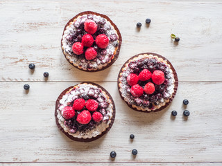 Fototapeta na wymiar tarts with fresh raspberries and blueberry