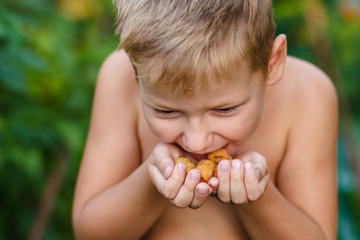 Baby eats yellow raspberries