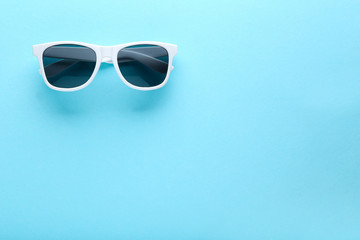 Modern sunglasses on blue background