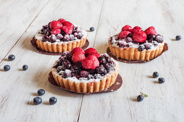 tarts with fresh raspberries and blueberry