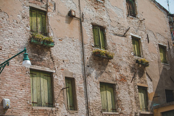 view of old break wall with windows with shutters