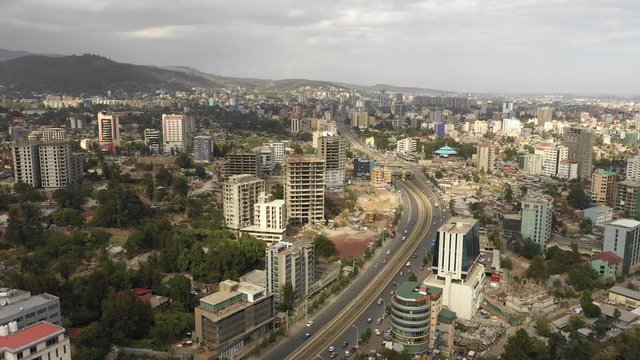 Aerial view flying over main highway through central Addis Ababa, urban development and transportation Ethiopia