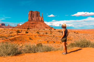 A girl in a black T-shirt in Monument Valley National Park in The Mittens and Merrick Butte point. Utah