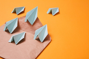 Concept for sending e-mails and e-commerce business. Email marketing. Paper planes flying out of...