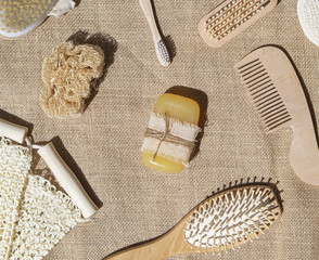Fototapeta na wymiar Flat lay arrangement with soap, comb and brushes